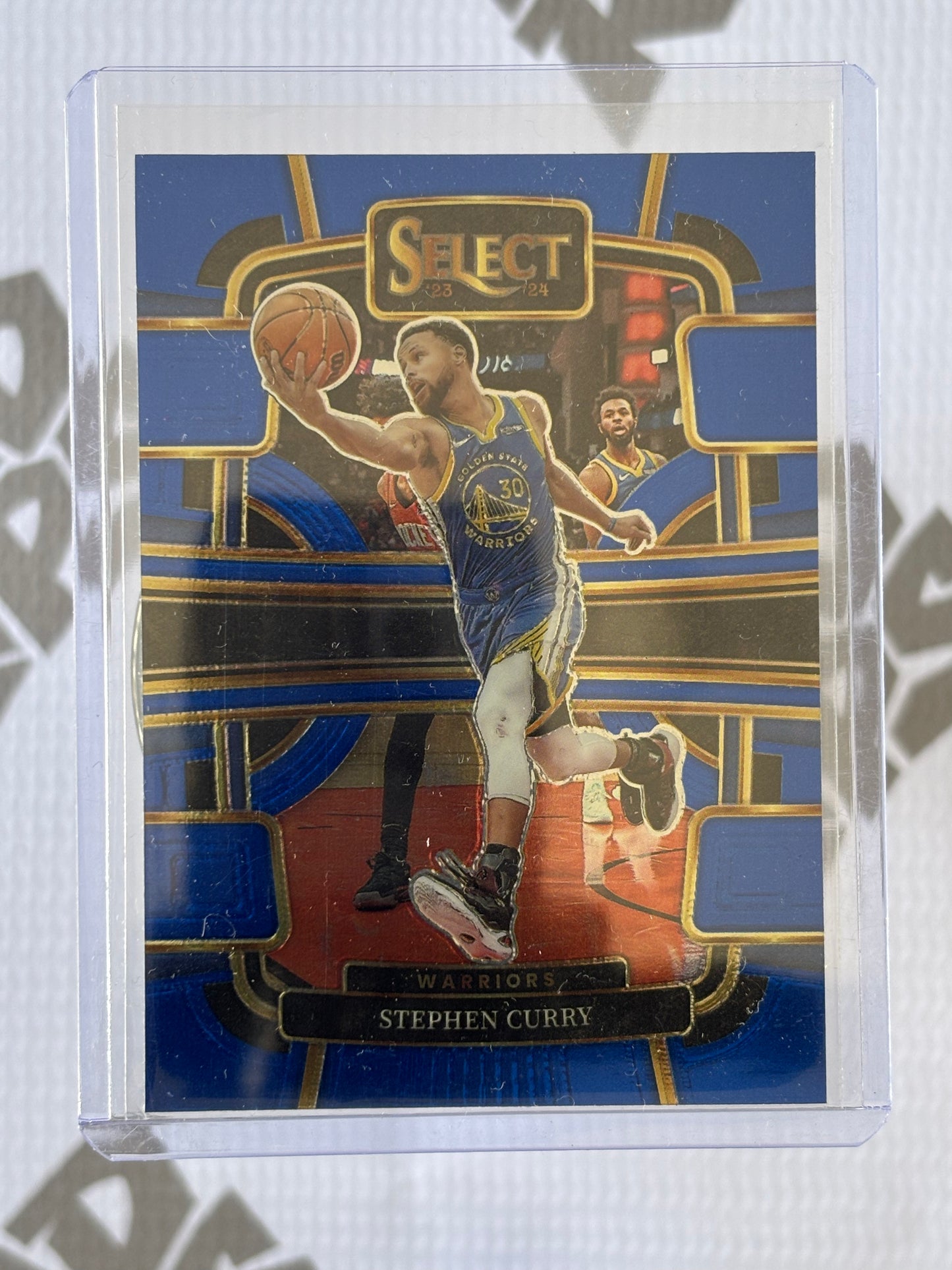 Stephen Curry /299 – 2023-24 Panini Select Blue Prizm Concourse (#56)